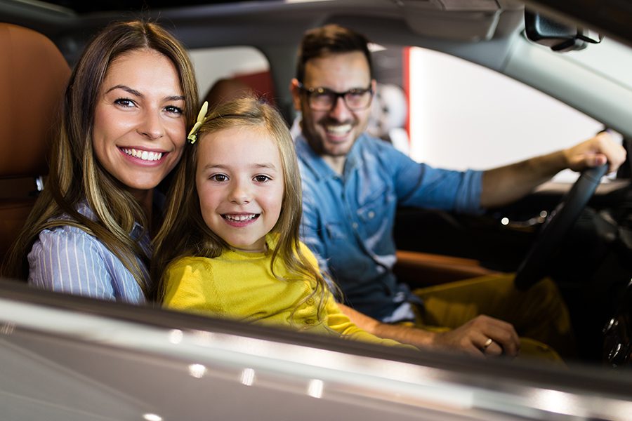 Personal Insurance - Happy Family Getting Ready to Buy a New Car in Showroom